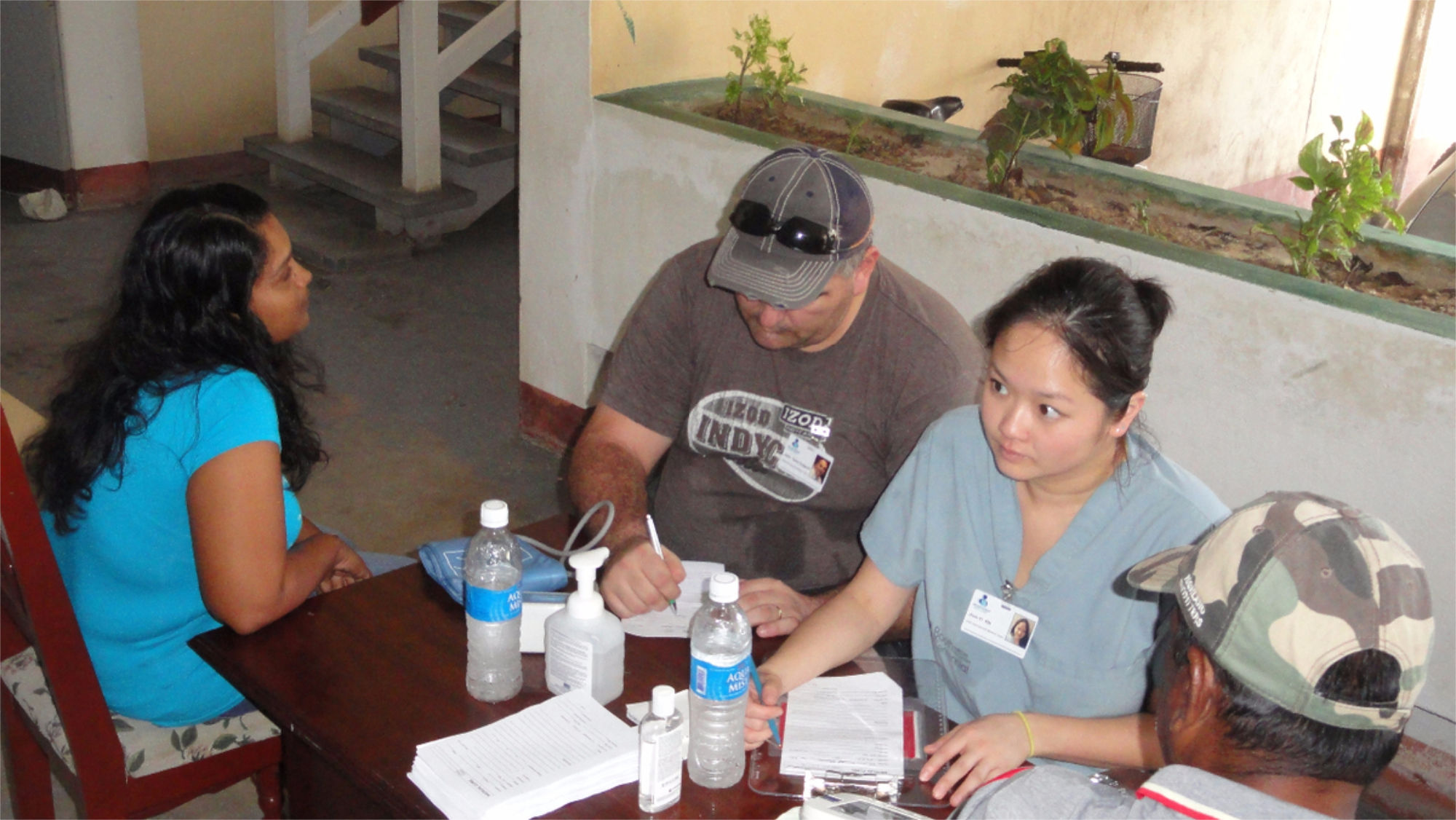 Patients filling out forms with nurse at nursing clinic